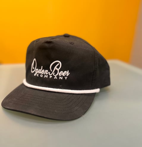 A 5-panel rope hat with a custom logo.